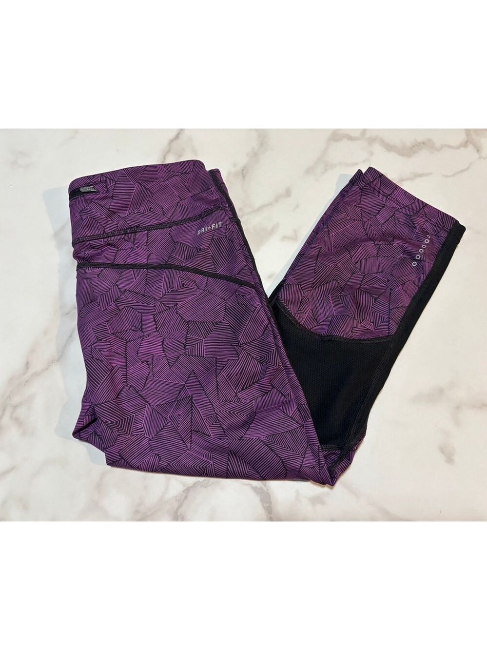 Nike Dri-FIT running leggings in a purple and black